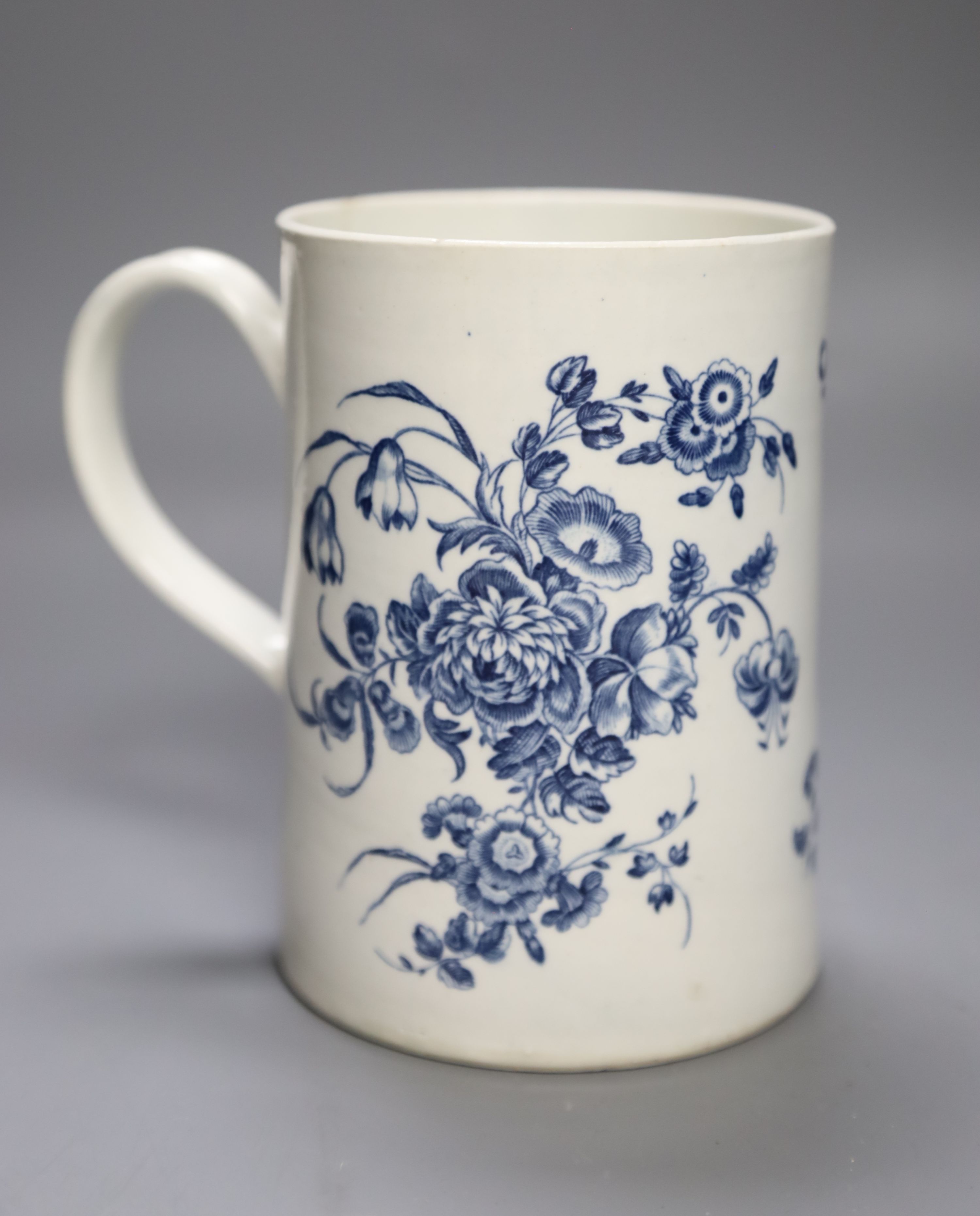 A Worcester cylindrical mug decorated in blue under glaze two large floral sprays, height 14cm